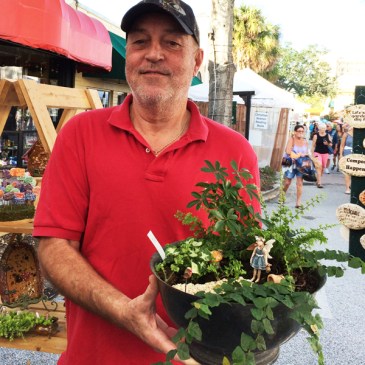 Man holding dish fairy garden